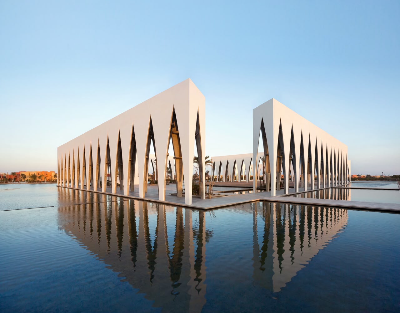 The sculptural festival plaza reflected in water