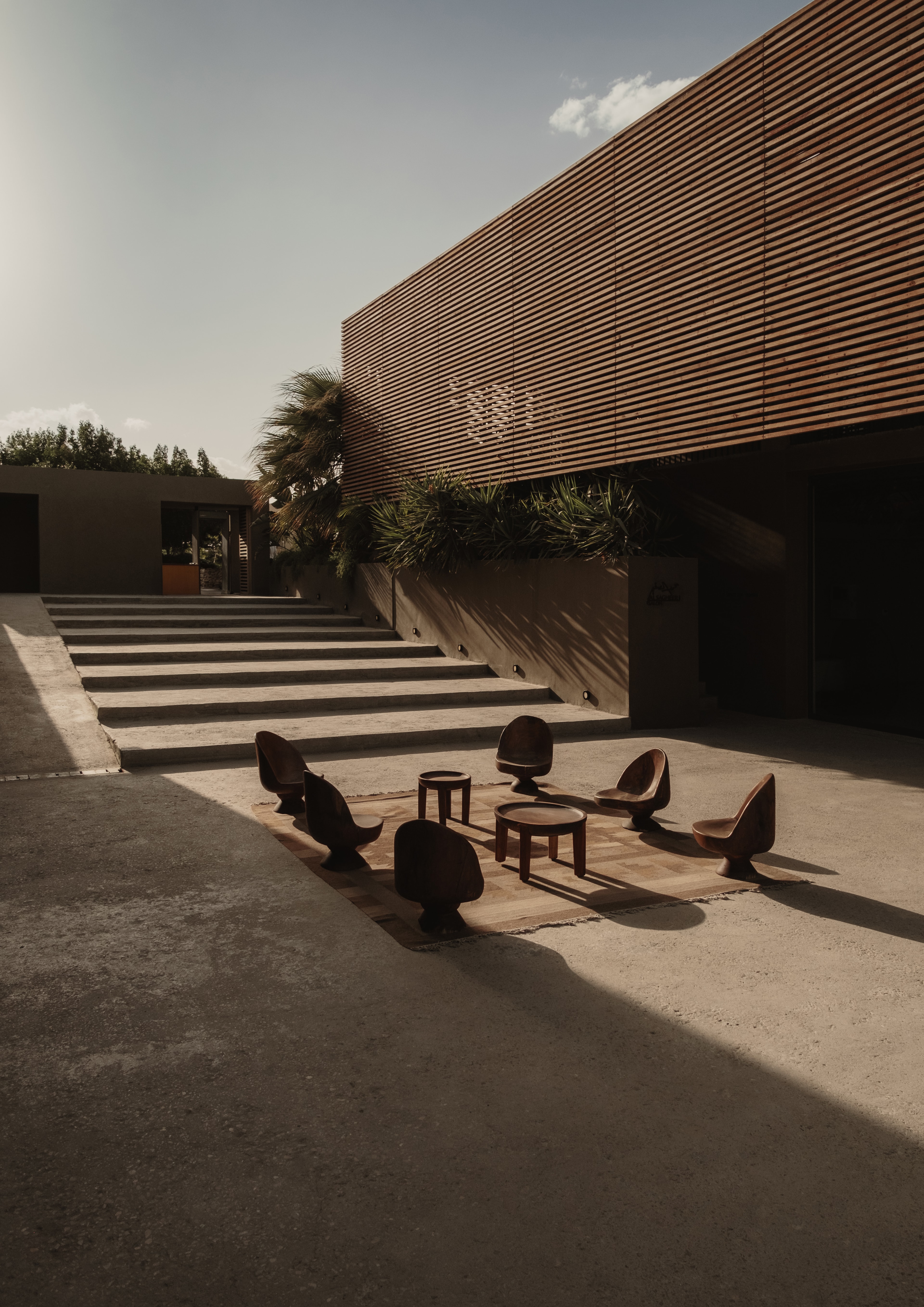 A circle of chairs arranged for conversation in an architectural courtyard