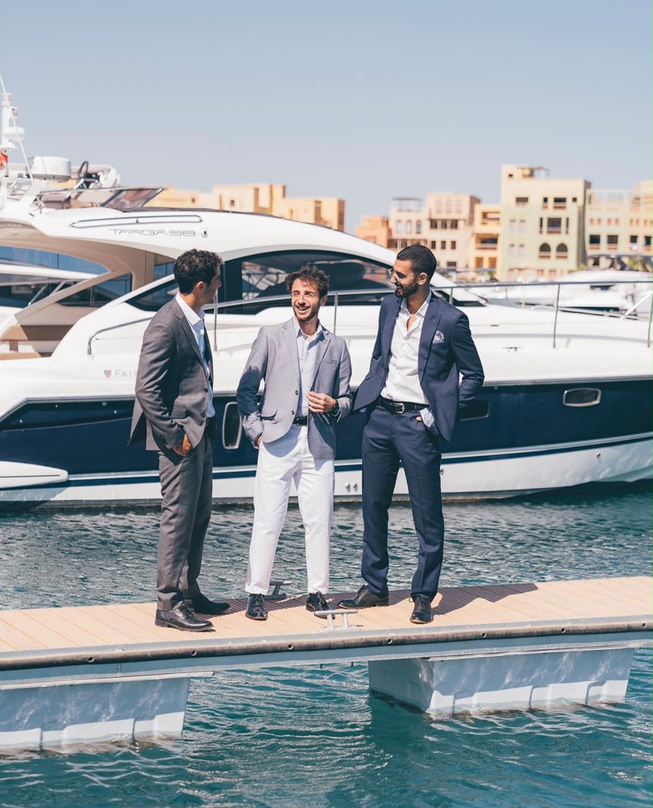 People talking beside a yacht
