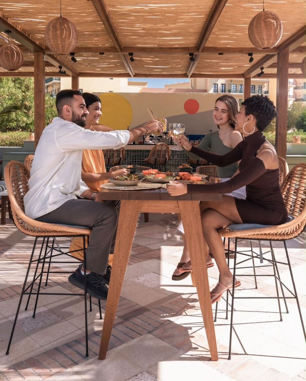 Four people sharing a meal and a toast